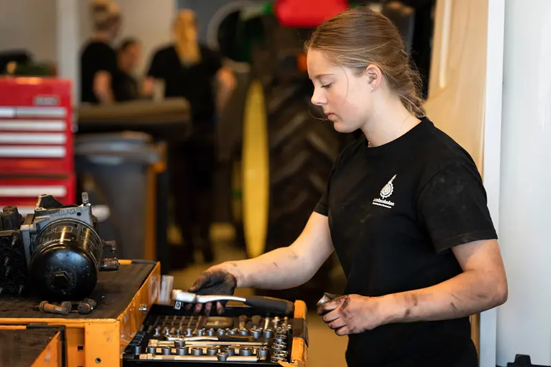 Elev som lägger verktyg i en låda